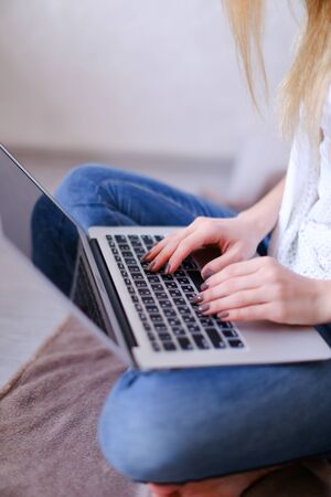 Closeup woman hands typing on laptop keyboard. Concept of copywriter profession and modern technology.の写真素材