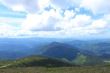 Blue and green wonderful Alps mountains with clouds in background. Concept of nature landscapes.の写真素材