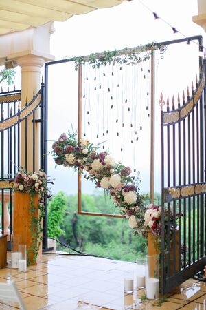Flower arch for wedding at restaurant. Concept of floristic decorations.の写真素材
