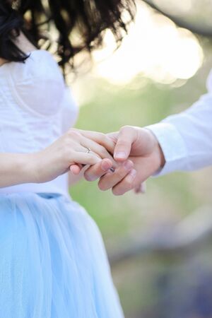 Closeup male and female hands holding each other. Concept of relationhip and feelings.の写真素材