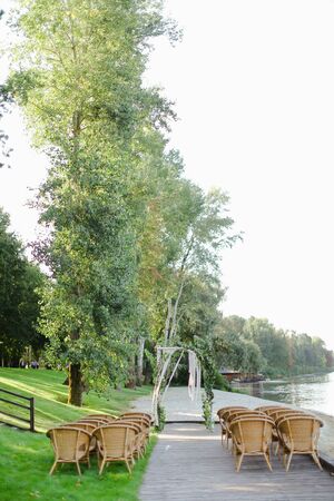 Birch bridal arch and chairs in park. Concept of wedding place for ceremony.の写真素材