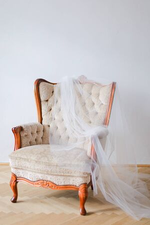 Arm chair and white bridal veil. Concept of wedding day and decorations.の写真素材