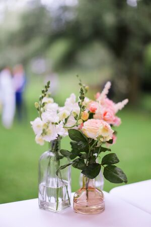 Pink flowers in vase on table. Concept of floristic art.の写真素材