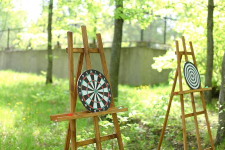 Darts targets on wooden easels in garden. Concept of active games and rest.の写真素材