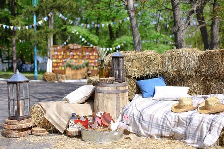 Hats and pillows on hay near bottles with wheat ears. Concept of summer vacations.の写真素材