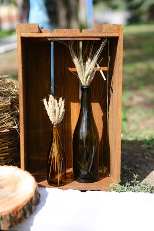 Wheel near hay and bottle with wheat ears.の写真素材