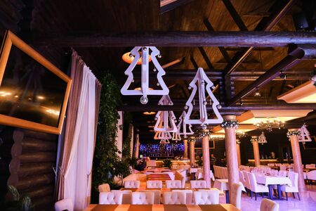 White fir tree decorations for Christmas on ceiling at restaurant. Concept of winter holidays.の写真素材