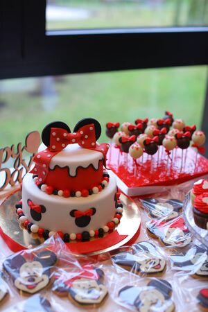 Red Mickey Mouse cake for birthday celebration. Concept of sweets for party.の写真素材