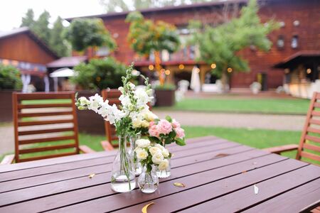 Flowers in vase on wooden table. Concept of restaurant and catering establishment.の写真素材