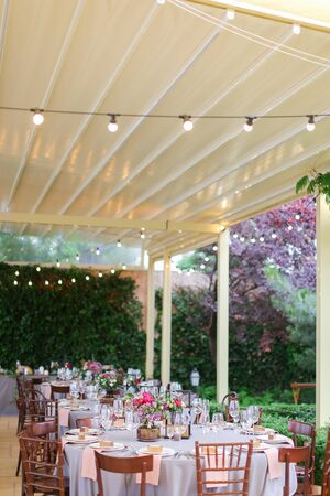 Served and decorated banquet table at restaurant in open air. Concept of catering establishment.の写真素材