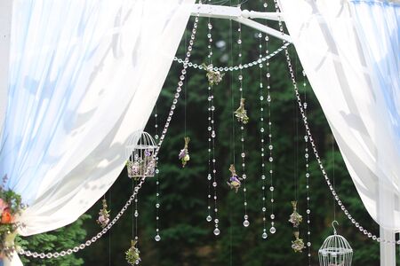 White bridal decorations for ceremony in green background. Concept of wedding elements.の写真素材