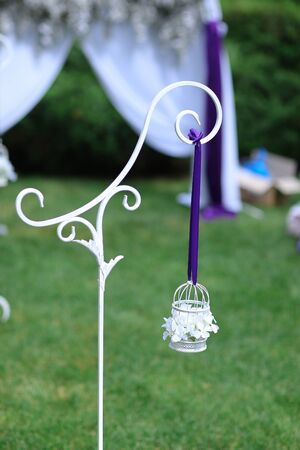 White little cute lantern hanging on violet ribbon. Concept of wedding decorations.の写真素材