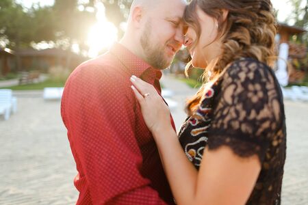 Bald caucasian man wearing red shirt and hugging woman. Concept of relationships and romantic love.の写真素材