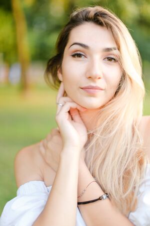 Portrait of young cute girl, green background. Concept of beauty and everyday makeup.の写真素材