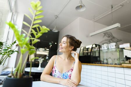 Young european woman sitting at cafe and having break. Concept of taking rest and beautiful female person.の写真素材