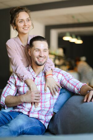 Young caucasian wife hugging husband at home. Concept of happy couple, relationship and love.の写真素材