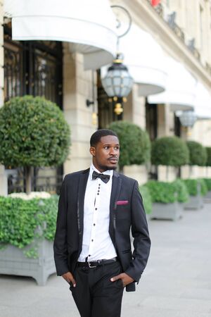 Afro american handsome man wearing suit and standing outside. Concept of black businessman.の写真素材