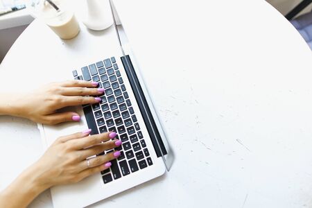 Arms texting on laptop keyboard, banner with white copyspace. Concept of hand typing speed and modern technology.の写真素材
