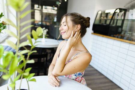 Young married american woman resting at cafe and resting. Concept of photo session at restaurant.の写真素材