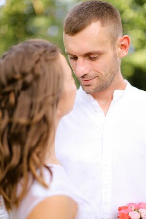 Happy groom in white shirt with caucasian bride. Concept of married couple and love.の写真素材