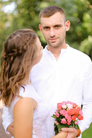 Happy european groom with caucasian bride. Concept of married couple and love.の写真素材