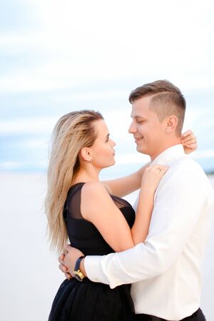 Portrait of girl hugging man in white background. Concept of love and relationship.の写真素材