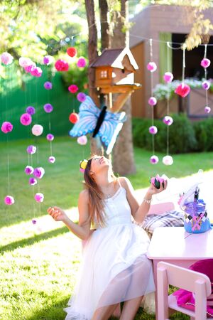 Young caucasian girl playing with bright decorations for summer camp.の写真素材