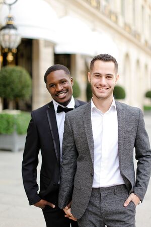 Afro american and caucasian gays walking outside in city. Concept of same sex male couple.の写真素材