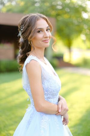 American nice bride walking in park. oncapt of bridal hair do and wedding photo session on nature.の写真素材
