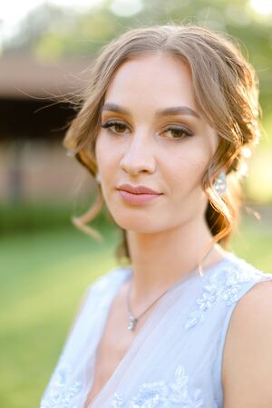 Close up portrait of caucasian pretty bride outside. Concept of beauty and bridal makeup.の写真素材