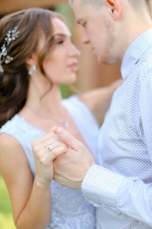 Close up fiancee dancing with groom outside. Concept of wedding and bridal photo session.の写真素材