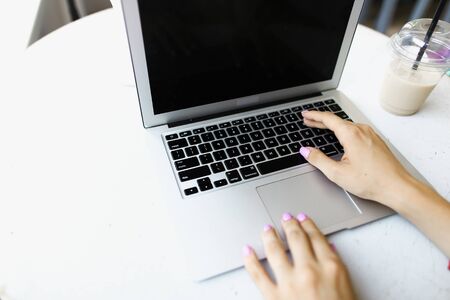 Arms texting on white laptop keyboard, banner with copyspace. Concept of hand typing speed and modern technology.の写真素材