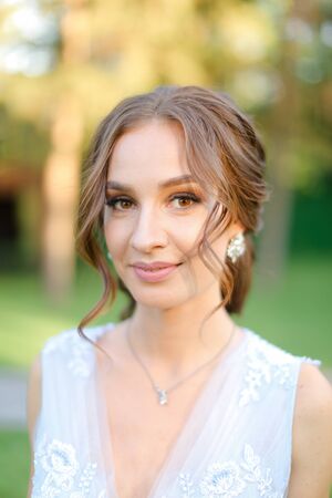 Close up portrait of caucasian fiancee with charming makeup outdoors. Concept of beauty and bridal photo session.の写真素材