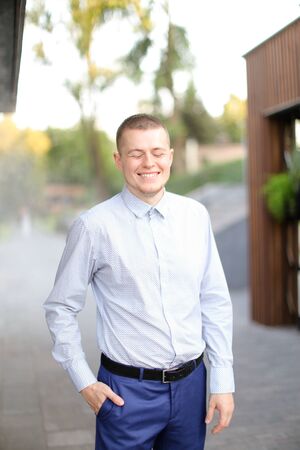 Caucasian happy man standing outside and wearing shirt. Concept of male person.の写真素材