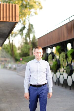 Caucasian young european man standing outside and wearing shirt. Concept of male person.の写真素材
