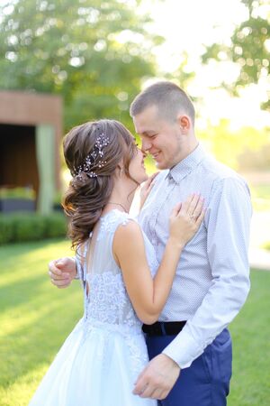 Young american fiancee dancing with groom in park. Concept of wedding and love.の写真素材