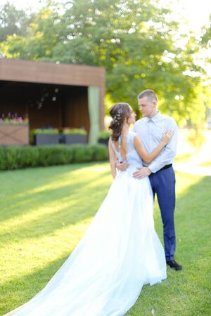 Young fiancee dancing with groom in garden. Concept of wedding and love.の写真素材