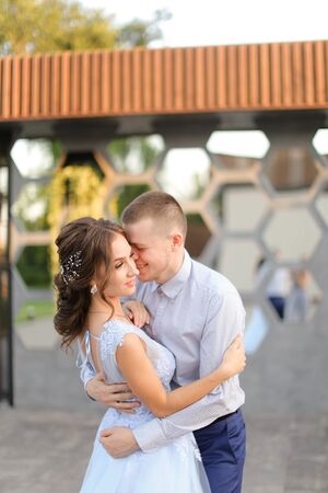 Caucasian fiancee and groom dancing outside. Concept of wedding photo session outdoor.の写真素材