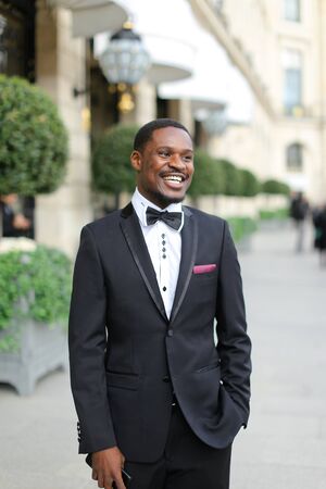 Afro american man wearing suit and standing outside. Concept of black businessman.の写真素材