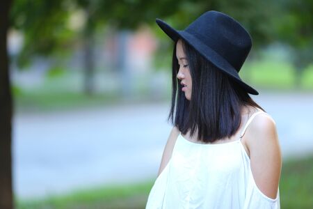 female hat nature summer sun sunset looks pleased. azitka woman black hair dancing around trees.の写真素材