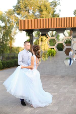 Caucasian amazing bride and groom dancing outside. Concept of wedding photo session outdoor.の写真素材