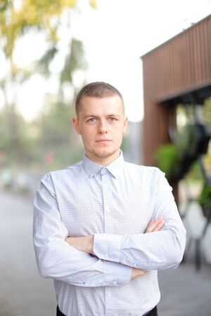 Caucasian handsome man standing outside and wearing shirt. Concept of male person.の写真素材