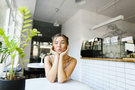 Young gorgeous woman sitting at cafe and having break. Concept of taking rest and beautiful female person.の写真素材
