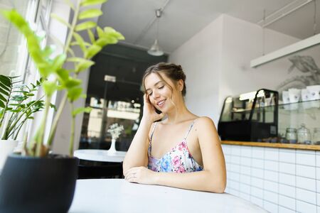 Young pretty woman resting at cafe and resting. Concept of photo session at restaurant.の写真素材