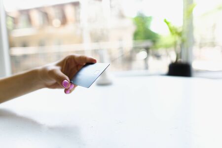 Close up hand keeping debit card at white office. Concept of bank account and credit.の写真素材