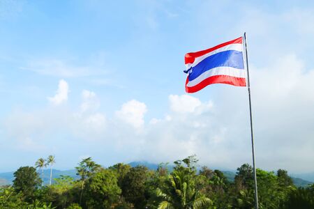 copy space flag of Thailand against blue sky, beautiful green nature and mountains, blue white and red colours. photo taken from the statue of the Big Buddhaの写真素材