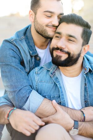 Caucasian european gays hugging and wearing jeans shirts. Concept of same sex couple and relationship.の写真素材