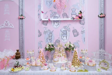 Many delightful sweet cakes and candies on decorated table. Concept of celebrating wedding and candy bar fow birthday.の写真素材