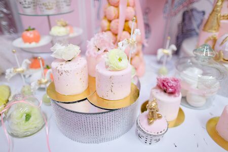 Many yummy sweets, cakes and candies on decorated table. Concept of celebrating wedding and candy bar fow birthday.の写真素材