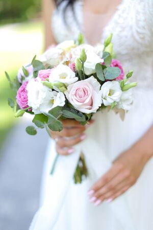 Close up bride bouquet of white roses. Concept of photo session and flowers composition.の写真素材